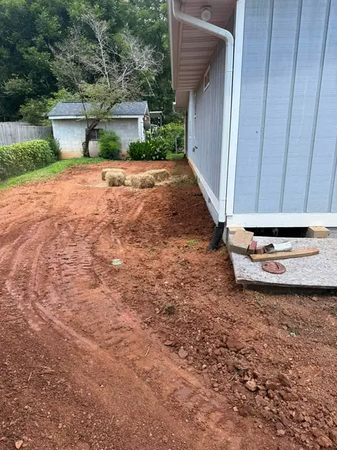 Regraded yard sloping away from a house