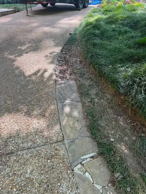 Gravel drive with a stone-lined drainage swale