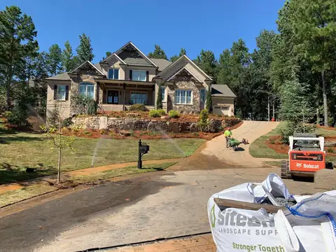 Front landscape with new plantings and a stone wall
