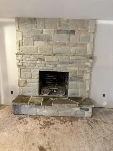 Stone fireplace with a flagstone hearth