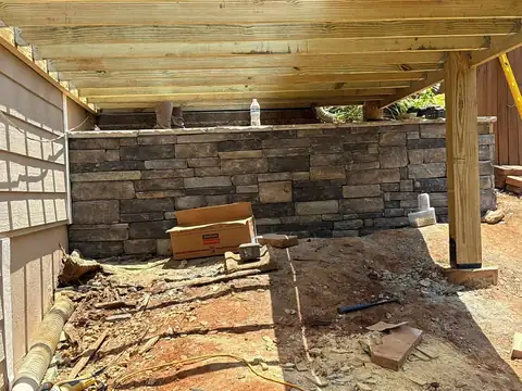 Stone veneer skirting under a raised porch