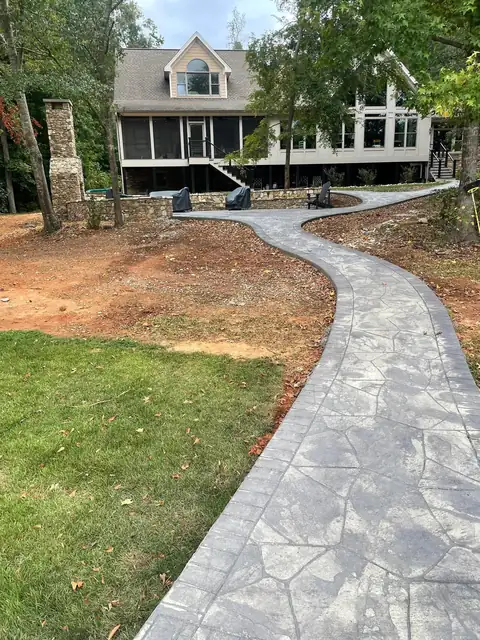 Stamped concrete walkway curving toward the house