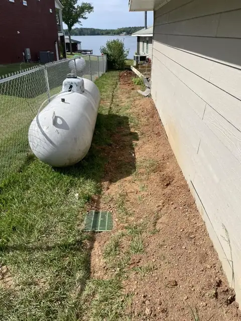 Side yard regraded with a catch basin