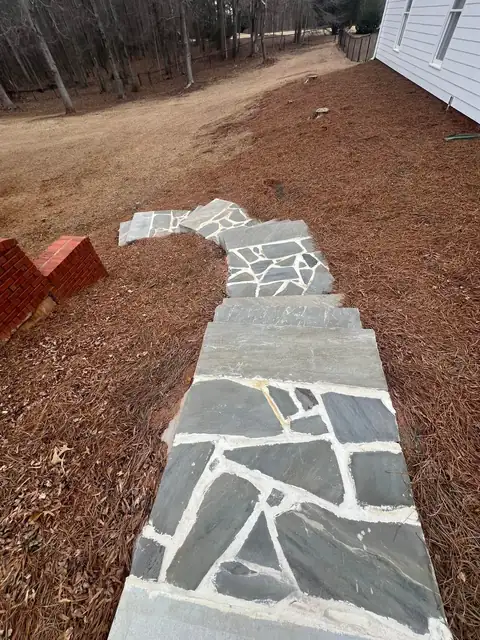 Irregular flagstone path set in pine straw