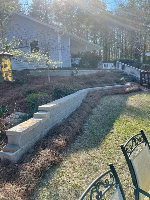 Tiered block retaining walls on a sloped backyard