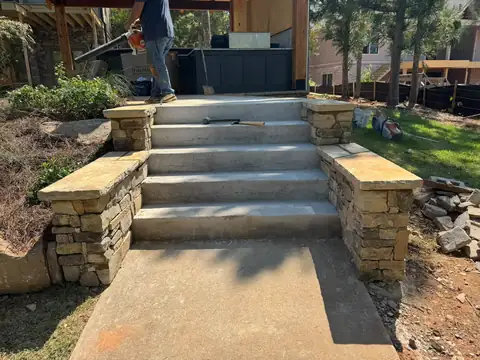 Concrete steps flanked by capped stone walls