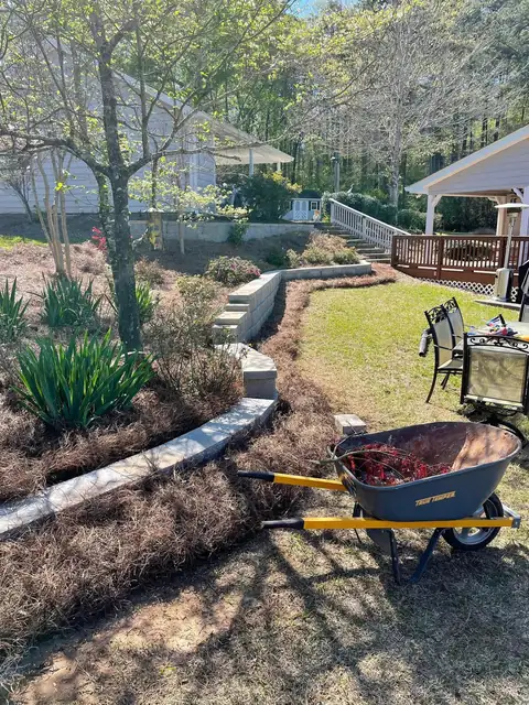 Block retaining wall stepping down a garden slope